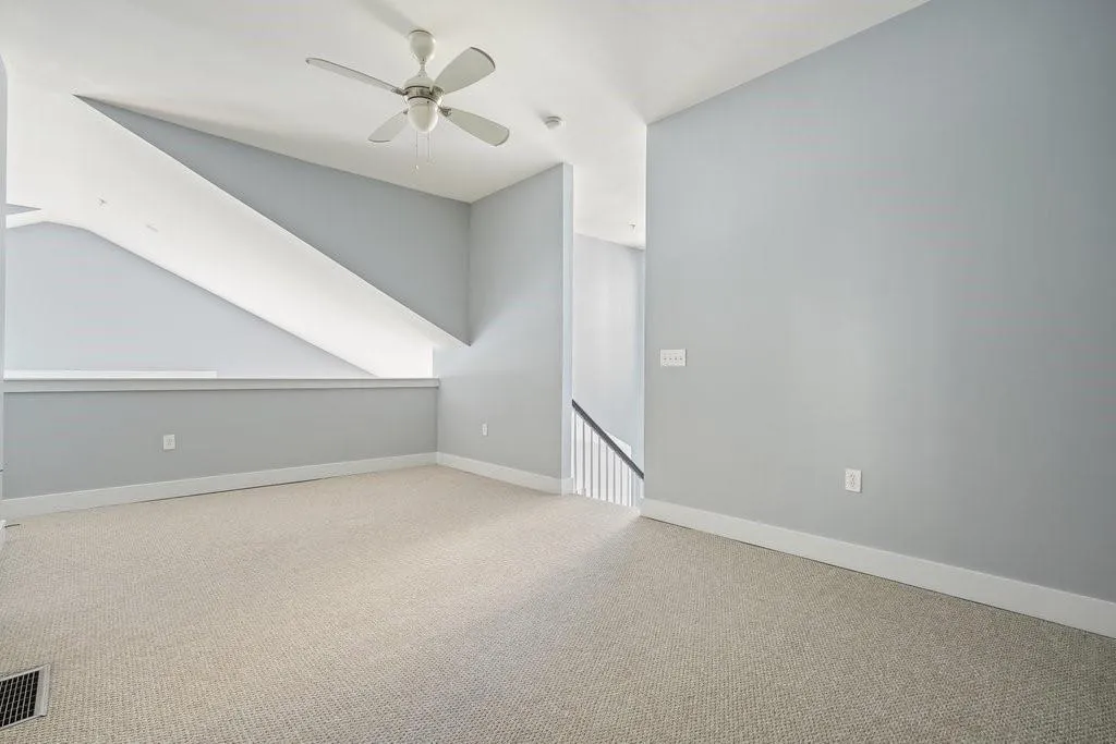Bonus room with light carpet, ceiling fan, and vaulted ceiling Bonus room with light carpet, ceiling fan, and vaulted ceiling