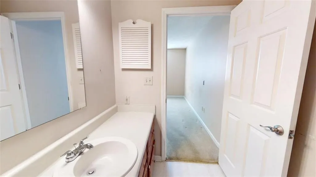 Bathroom with vanity and baseboards