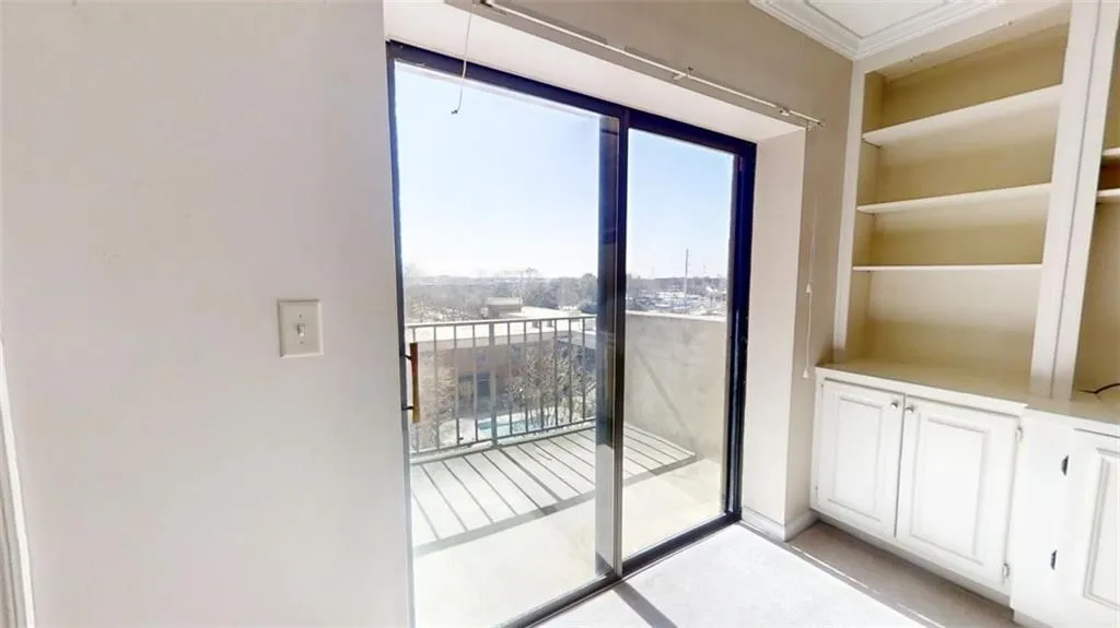 Doorway to outside featuring crown molding