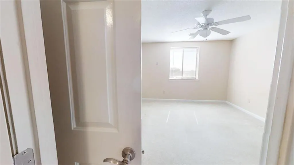 Unfurnished room with a ceiling fan and baseboards