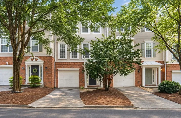 Brick and siding exterior with individual garages and covered entryways