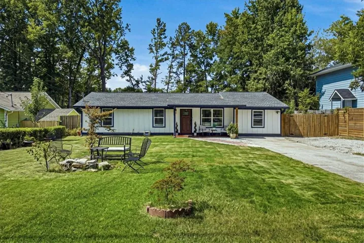 Single-story exterior with white siding and dark trim