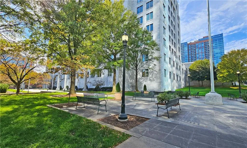 View of home's community with a patio area and a lawn