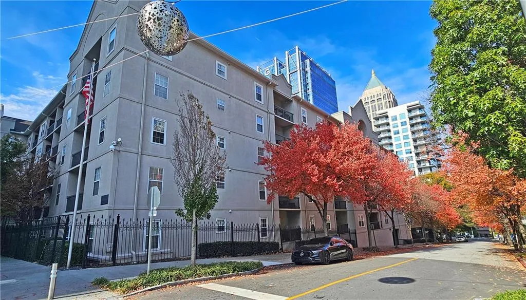 View of building exterior featuring fence