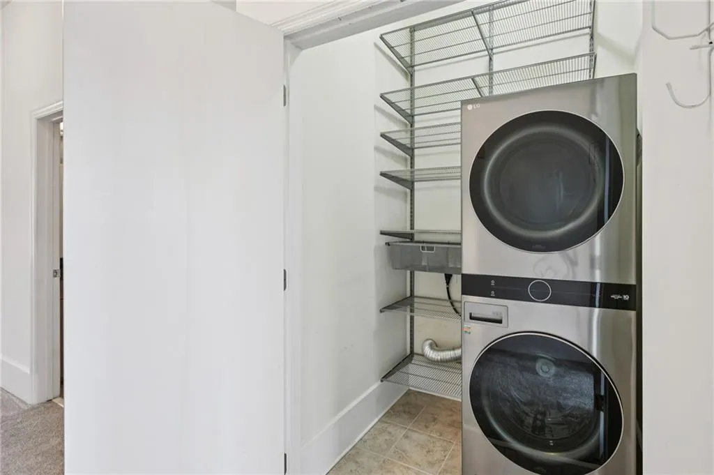 Top floor Laundry area with 5yo stacked washer / dryer and custom shelving. Washer/dryer comes with the sale of unit!