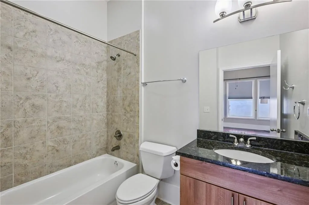 En suite full bath off guest bedroom. Granite vanity.