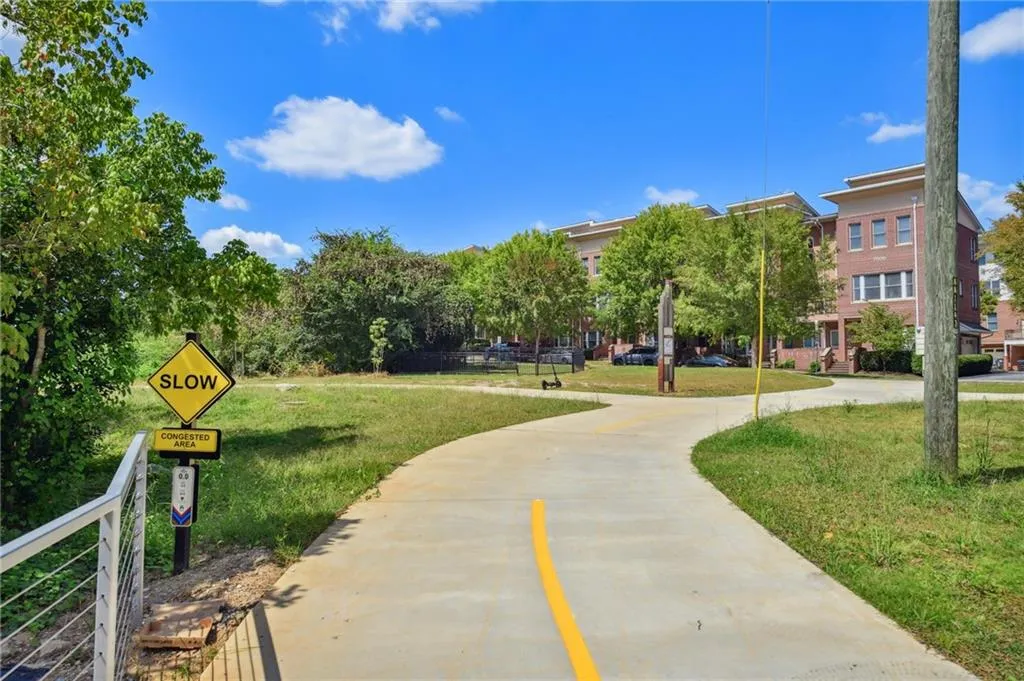 Leaving the pedestrian bridge looking over the park + dog-friendly area toward front of home.