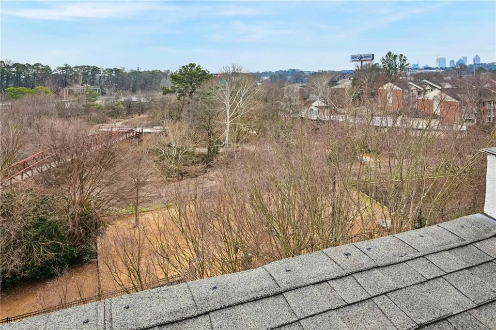 Look over the edge of the rooftop deck to the park and Confluence pedestrian bridge below.