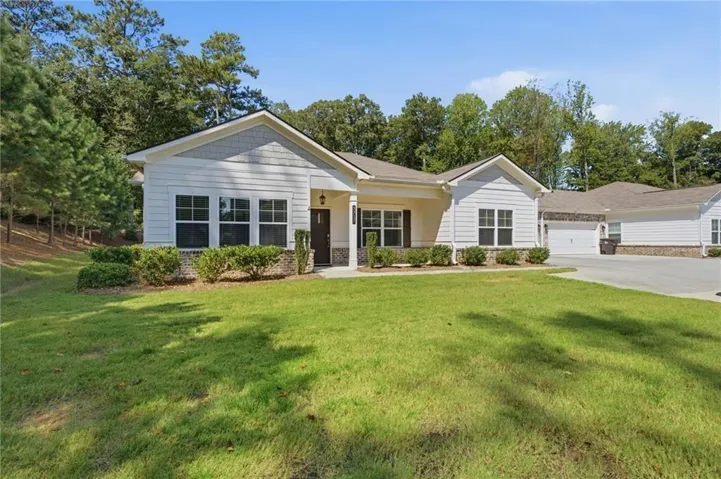 Contemporary exterior with white siding, brick accents, and a covered entry