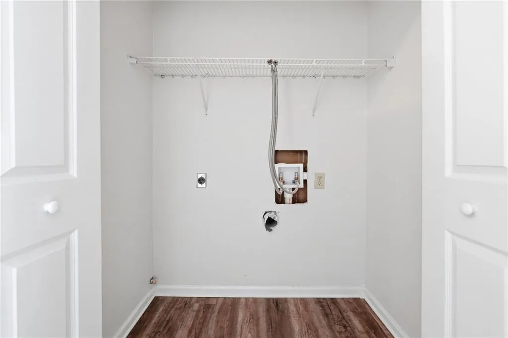 Laundry area featuring hookup for a washing machine, wood finished floors, and hookup for an electric dryer