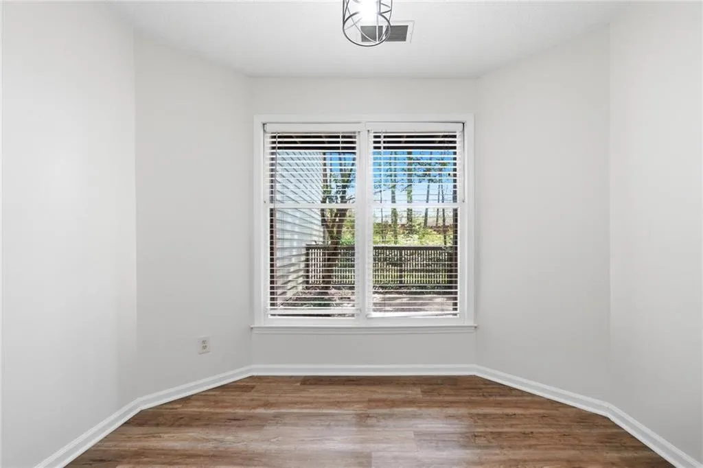 Spare room with wood finished floors and baseboards