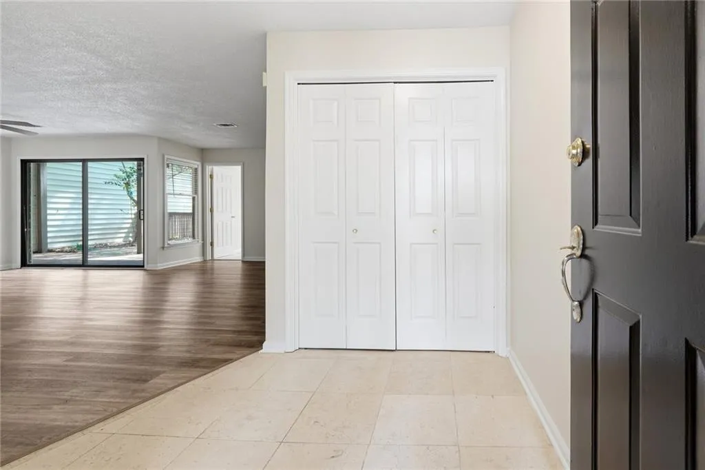 Foyer featuring light tile patterned floors and a textured ceiling