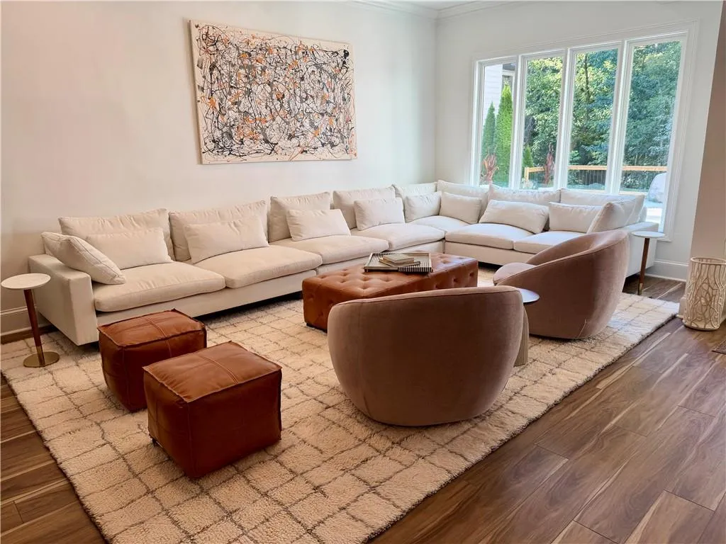 Expansive floor-to-ceiling windows, wood-finish flooring, and crown molding