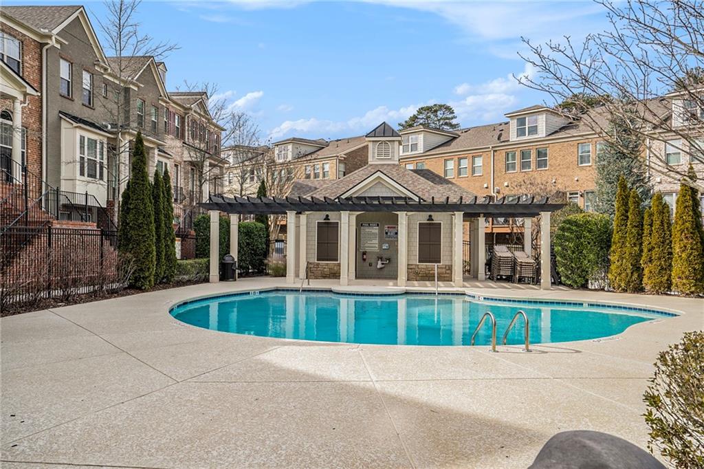 View of pool featuring a pergola and a patio area