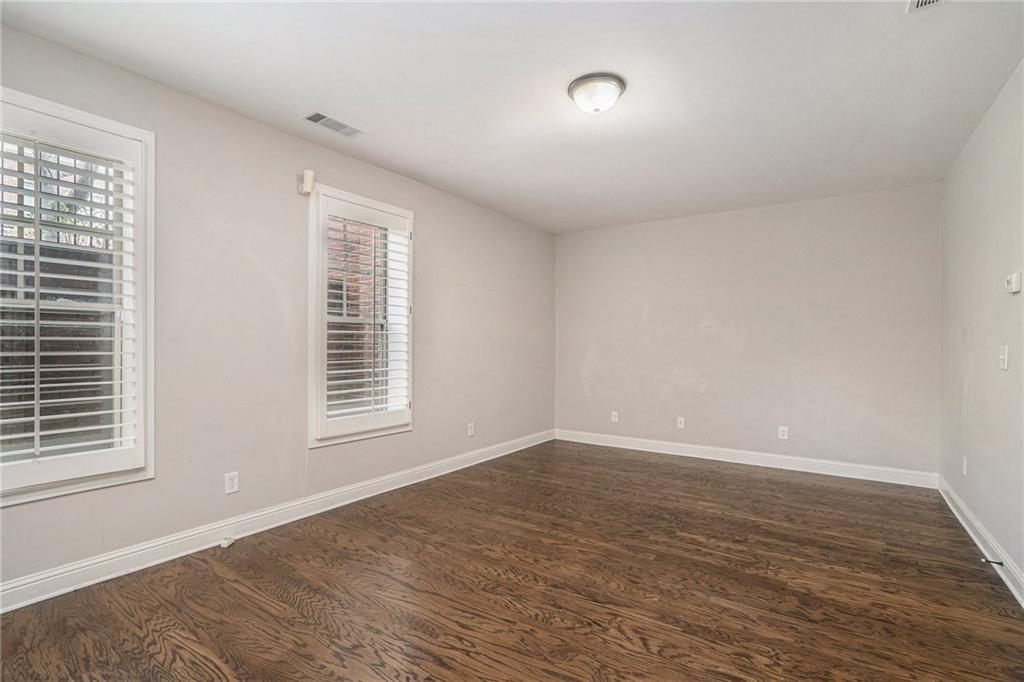 Unfurnished room featuring dark wood-type flooring