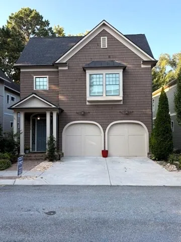 Shingle siding exterior with a dark roof and white trim
