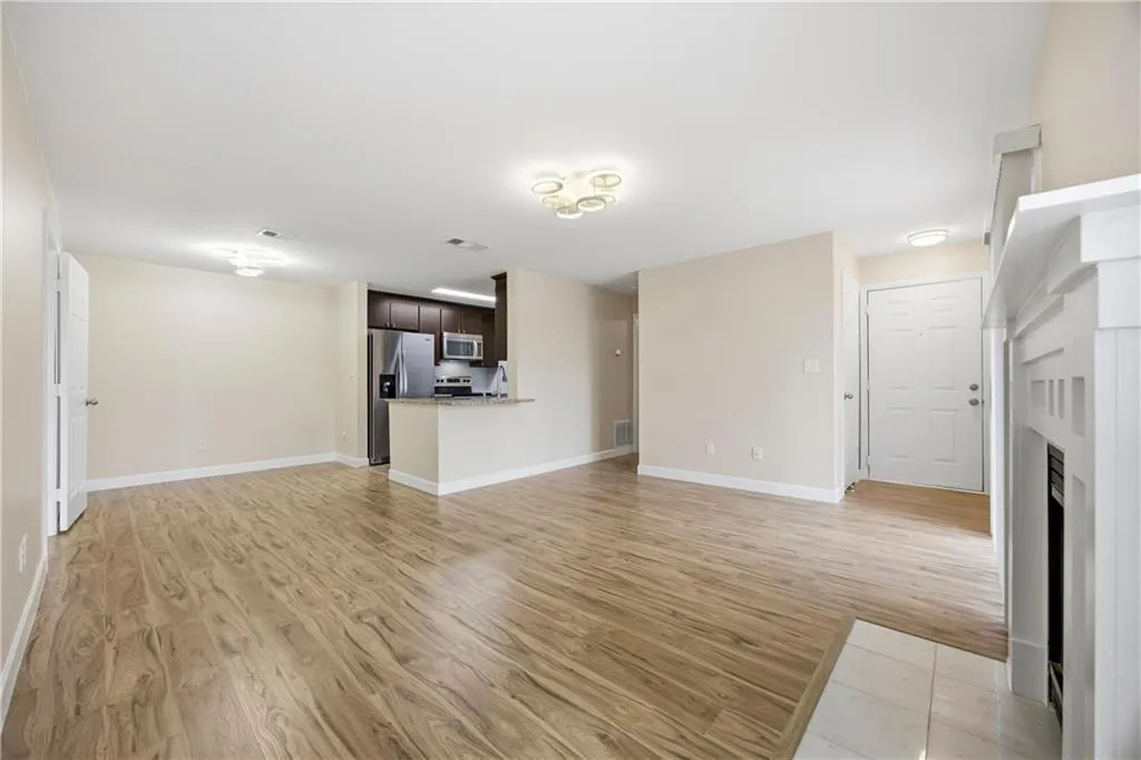 Unfurnished living room with light wood-style flooring and a fireplace