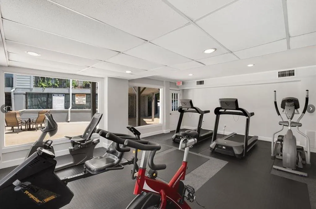 Workout area featuring recessed lighting and a drop ceiling