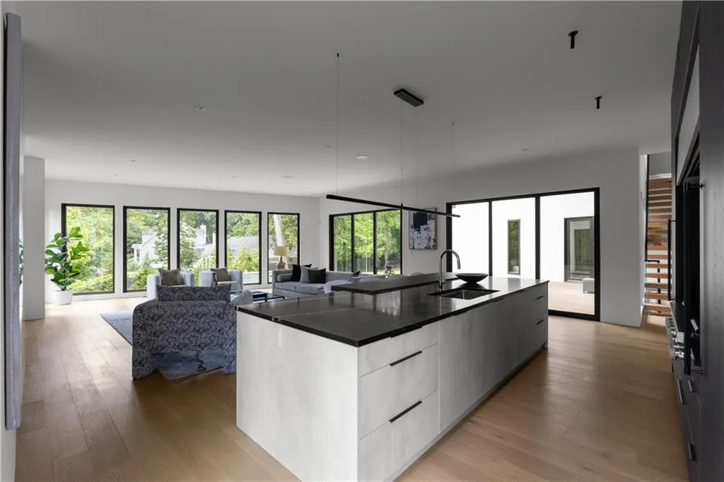 Kitchen with modern cabinets, open floor plan, and healthy amount of natural light