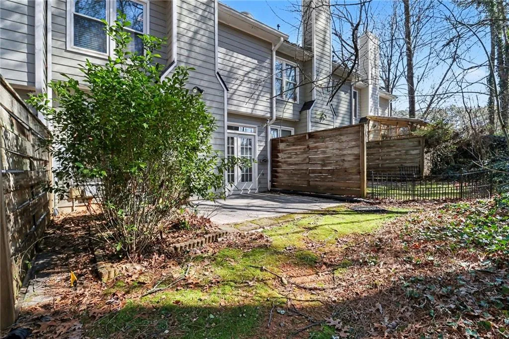 Back of property featuring a chimney and a patio area