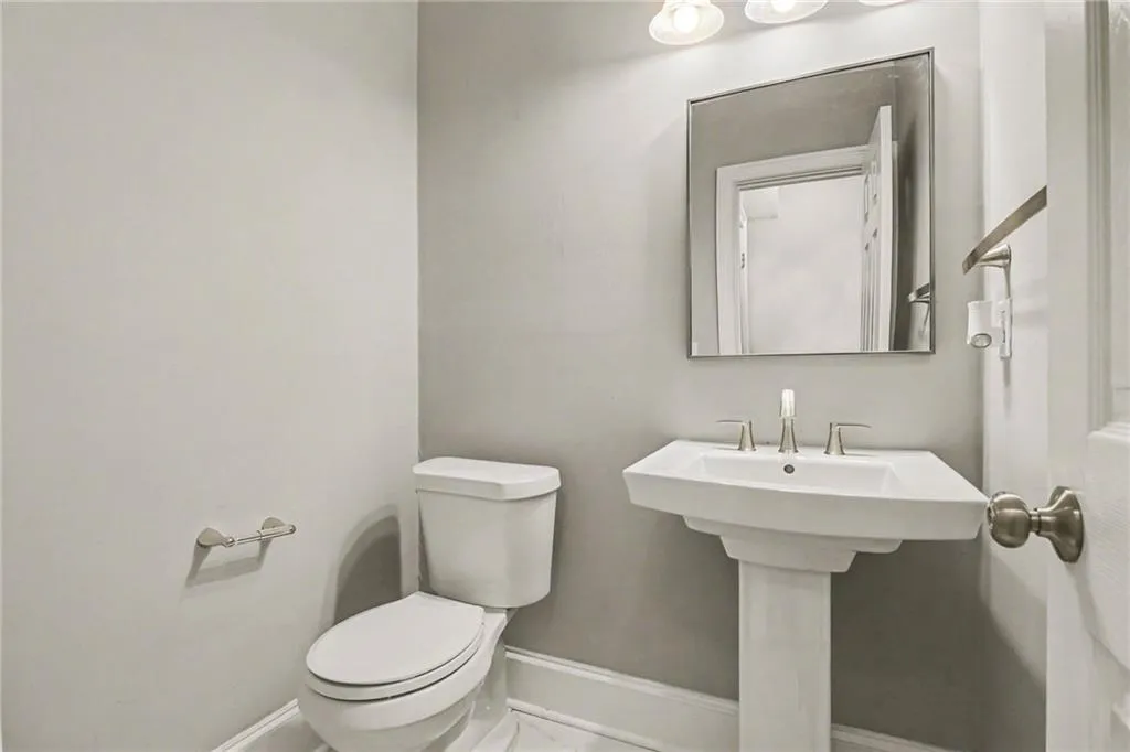 Bathroom with toilet and baseboards