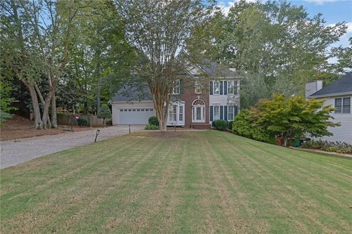 Brick and siding exterior with dark shutters