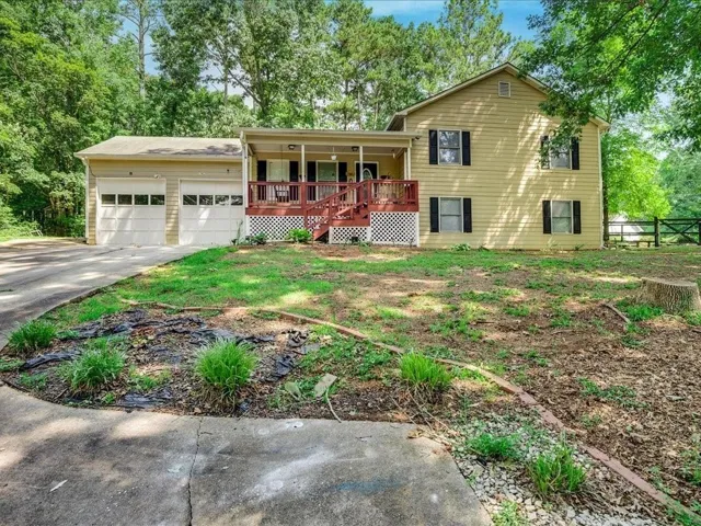 Two-story residence with a covered front porch, two-car garage, and a concrete driveway