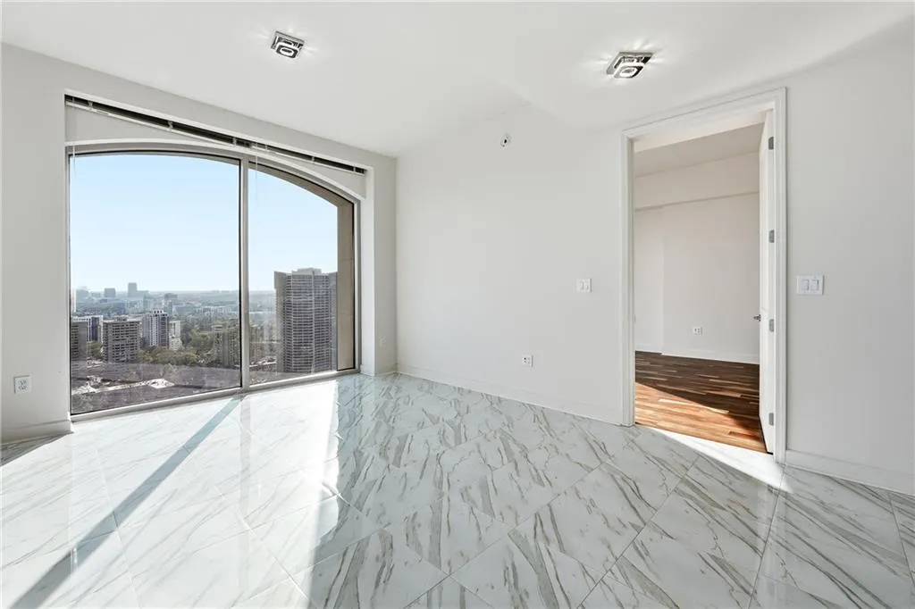 Empty room with marble look tiles and a view of city