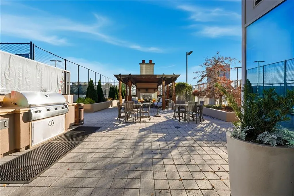 View of patio / terrace featuring outdoor dining space, an outdoor fireplace, and exterior kitchen
