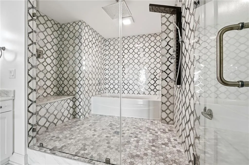 Full bath featuring tiled shower