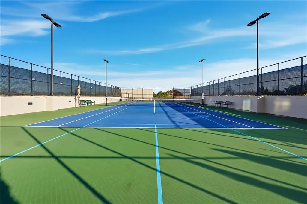 View of tennis court featuring community basketball court