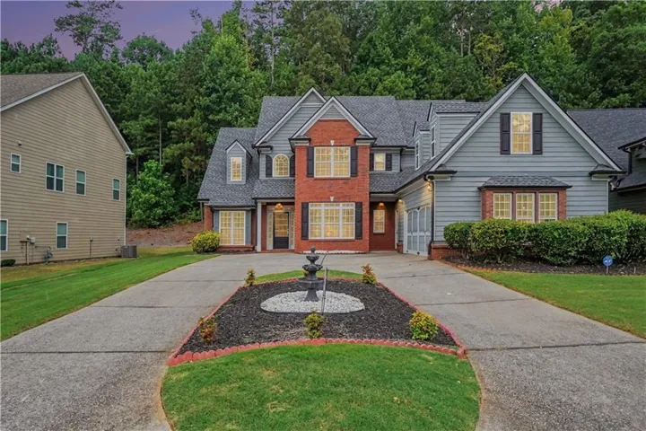 Brick and siding exterior featuring multiple gables and dormer windows