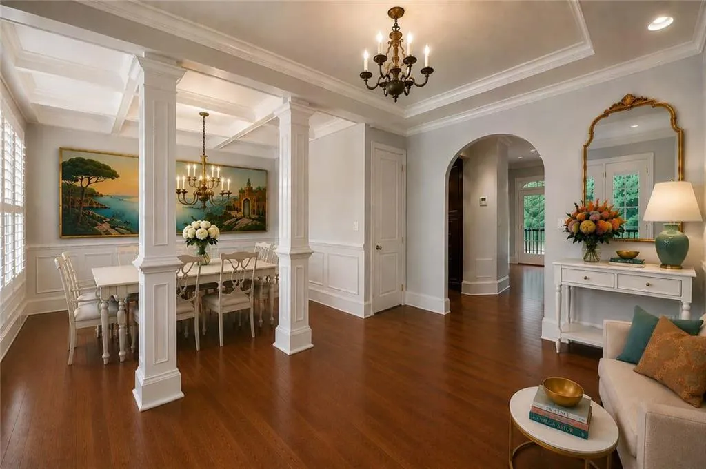 Enter the home to a spacious dining room and foyer with elegant columns and arched doorways