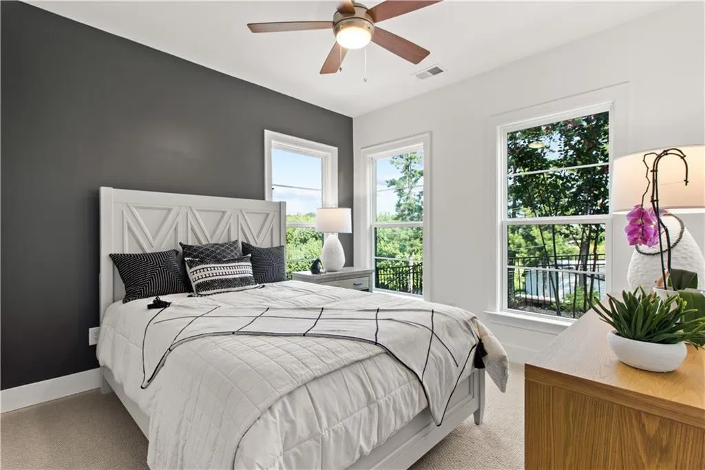 Lower level bedroom (or office) featuring carpet flooring and ceiling fan