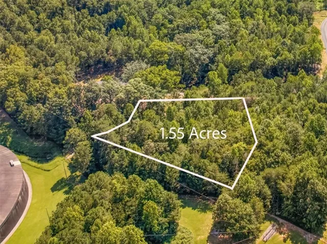 1.55 acres of undeveloped land featuring mature trees