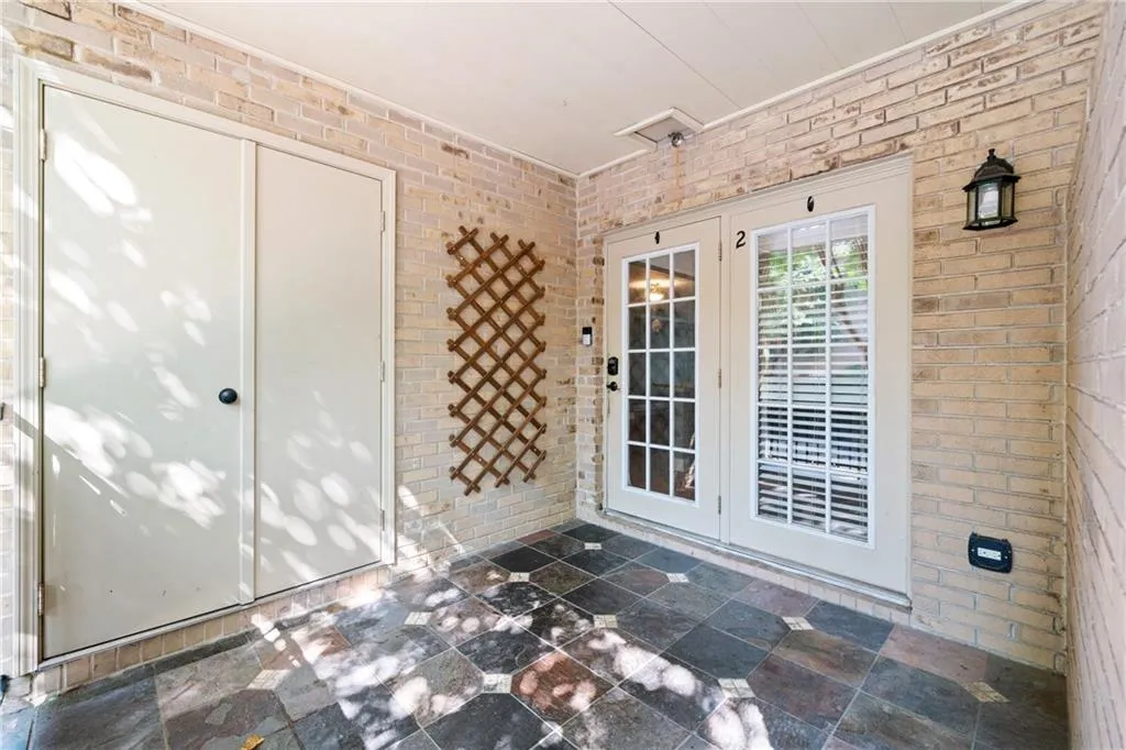 View of exterior entry with a patio area and french doors
