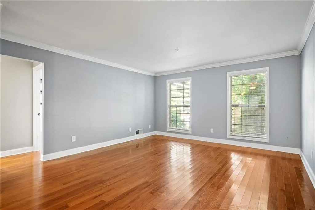 Unfurnished room with ornamental molding and light hardwood / wood-style floors