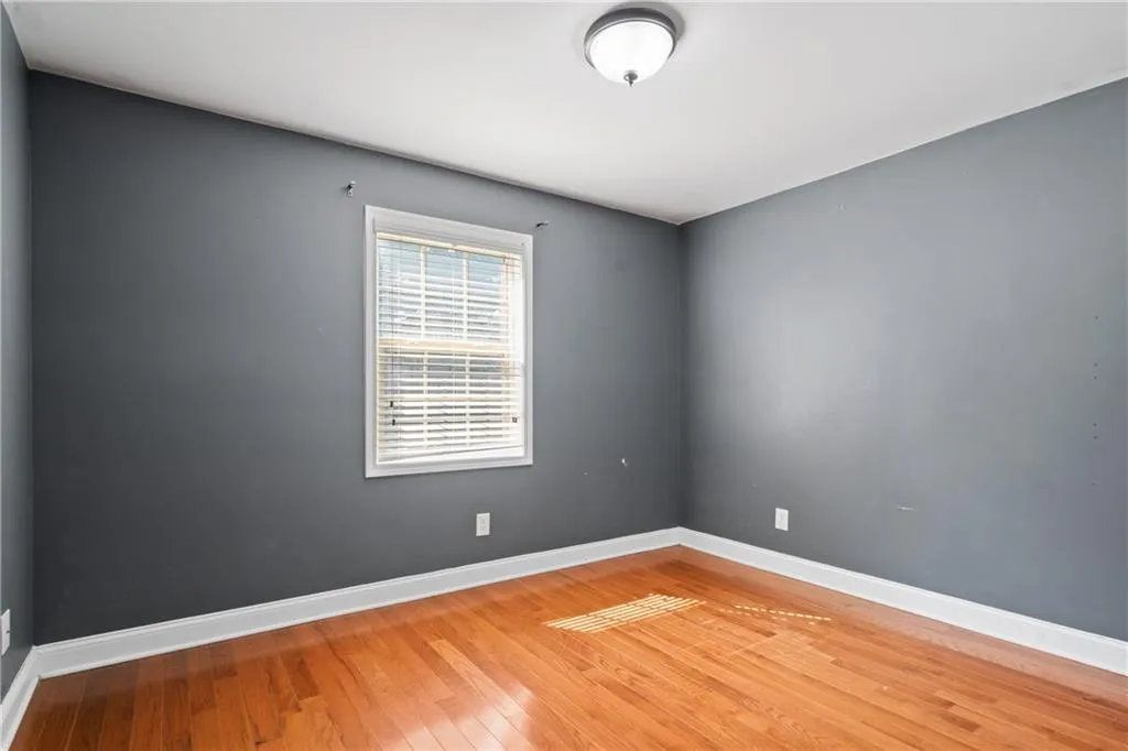 Empty room with hardwood / wood-style floors