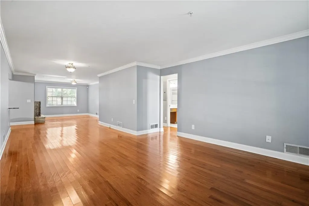 Unfurnished living room with crown molding and light hardwood / wood-style flooring