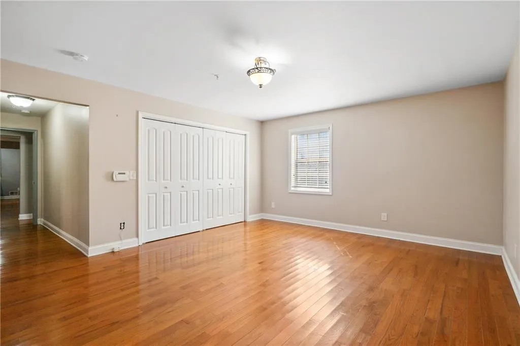 Unfurnished bedroom with hardwood / wood-style flooring