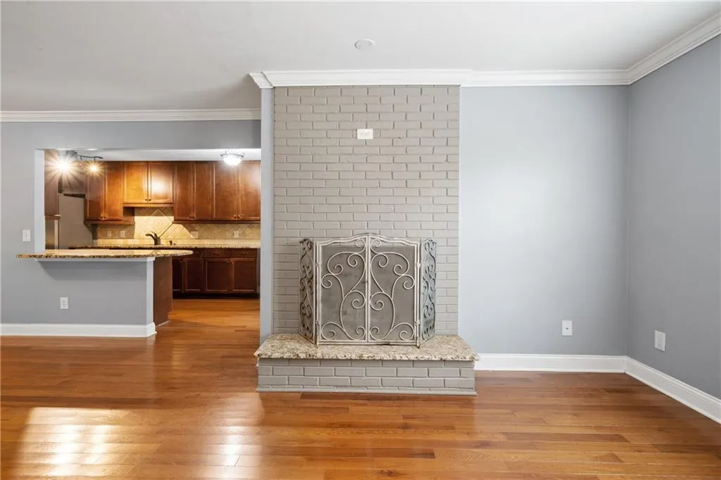 Unfurnished living room with crown molding, hardwood / wood-style flooring, and a fireplace