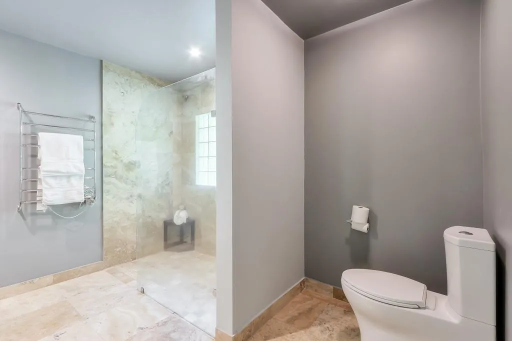 Bathroom featuring tile flooring and a tile shower