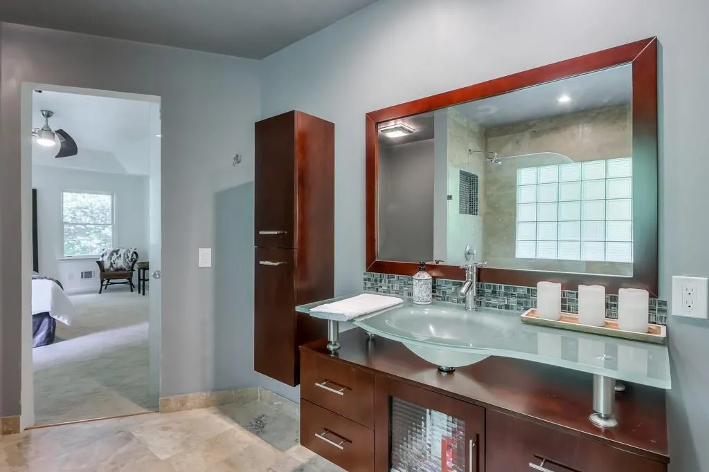 Bathroom with backsplash, tile floors, and vanity