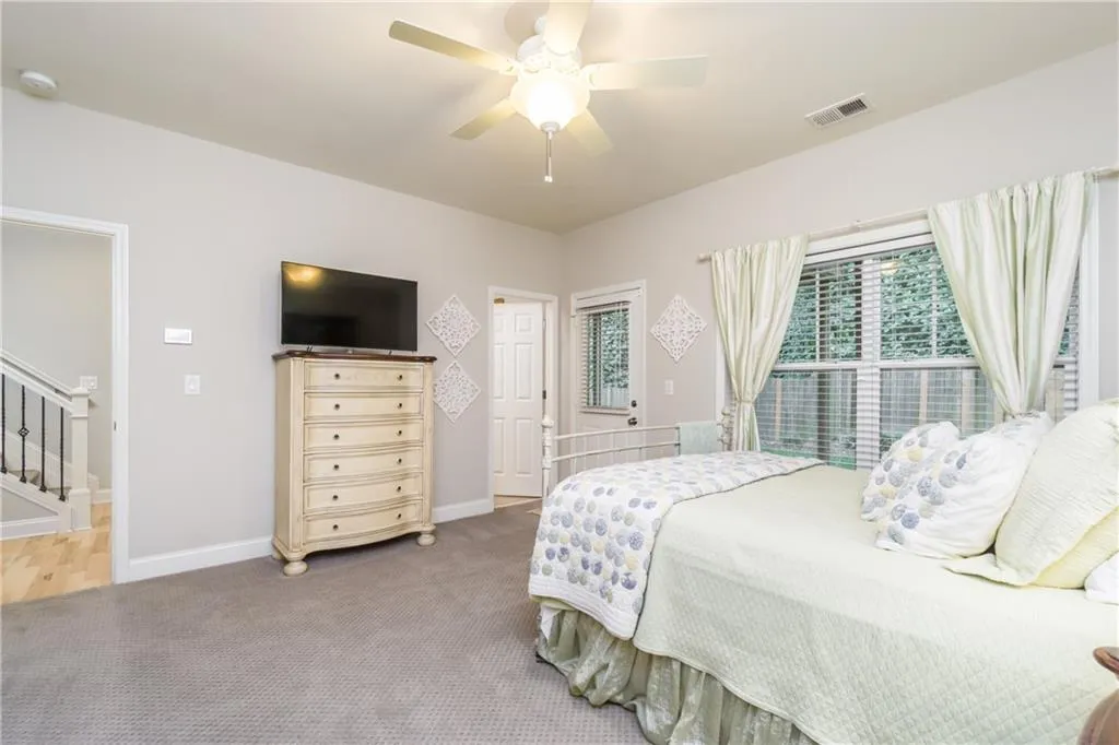 Bedroom featuring carpet and ceiling fan