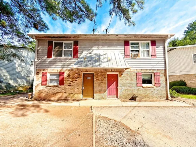 Two-story exterior featuring brick and horizontal siding