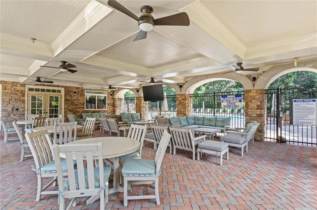 View of clubhouse patio with ceiling fan and french doors