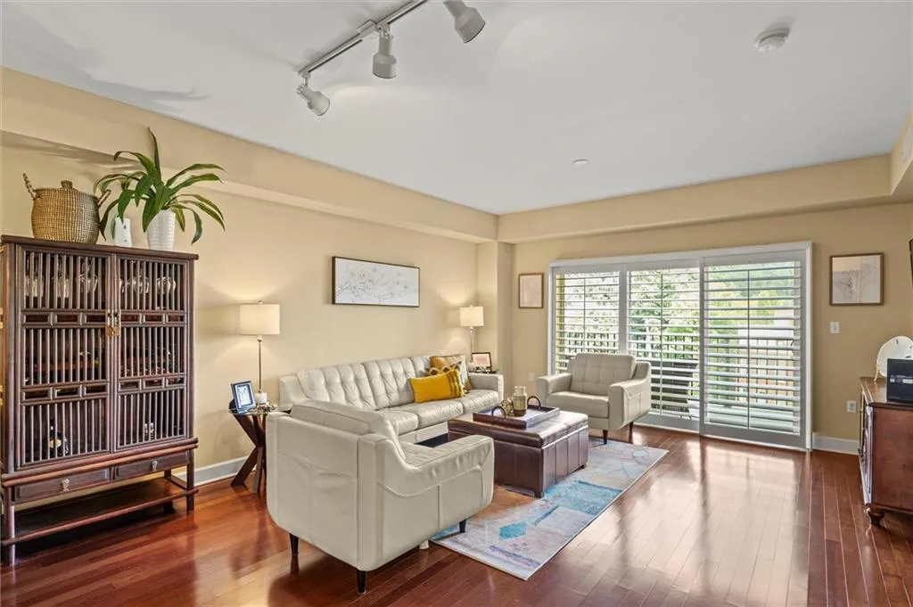 Living room featuring dark hardwood / wood-style flooring and rail lighting