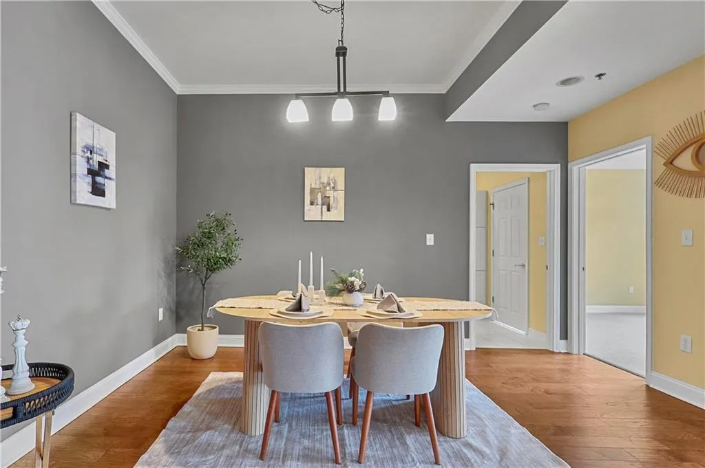 Dining area featuring crown molding, light wood-style floors, and track lighting