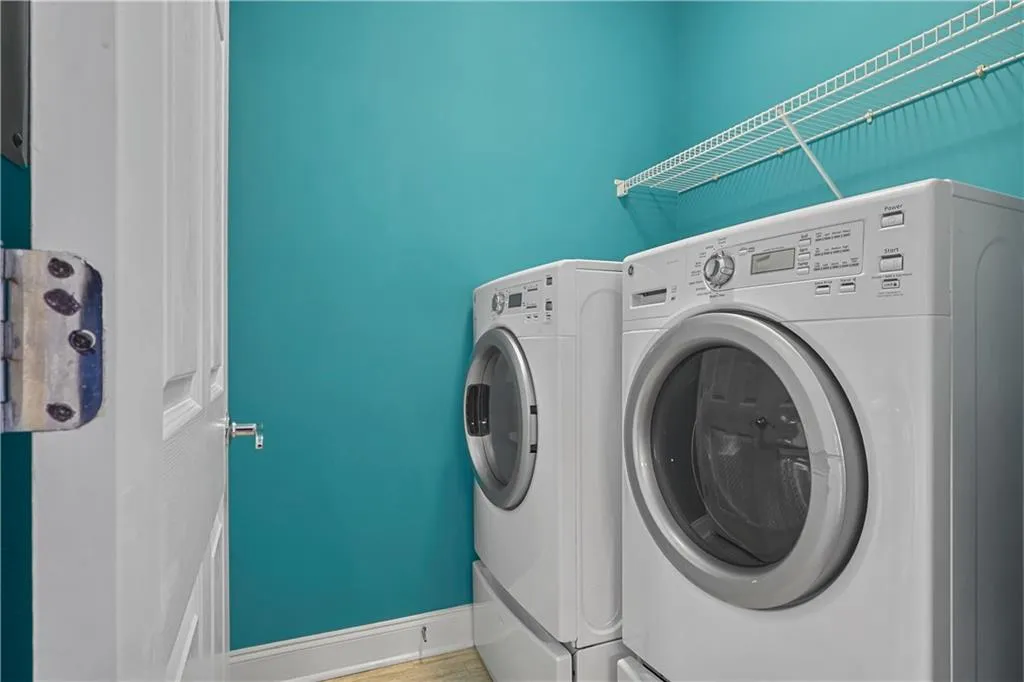 Laundry room featuring baseboards and washing machine and clothes dryer