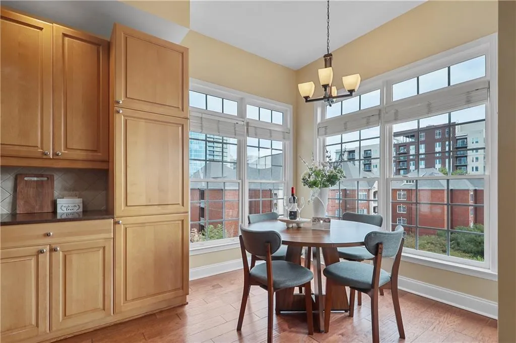 Dining room featuring light wood-type flooring, plenty of natural light, and a chandelier